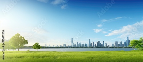 Scenic view of a grassy field with buildings and water in the background providing a beautiful copy space image