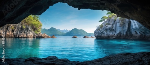 Scenic view of a turquoise lake framed by a cave with available copy space image