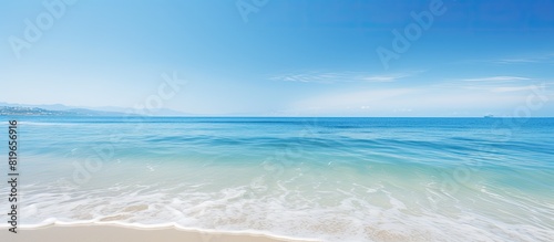 Scenic beach with crystal blue ocean and clear sky perfect for a copy space image