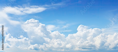 Blue sky with fluffy clouds creates a serene atmosphere in the copy space image