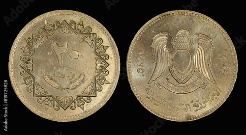 Vintage Libyan Jamahiriya dinar coins placed on a vibrant black background
