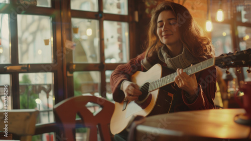 A woman plays guitar with closed eyes, engrossed in music at a cozy cafe filled with warmth and soul.