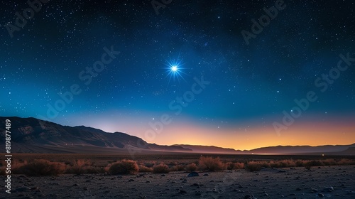This is a beautiful image of a starry night sky over a desert landscape. The bright shining star is the focal point of the image.