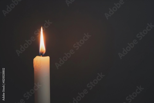 White Candle Burning in the Dark, Isolated on Black Background, Symbolizing Memorial Day Remembrance.