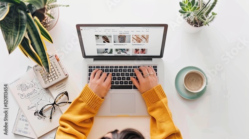 A woman in a cozy sweater shops for fall fashion on her laptop, displaying an array of stylish outfits on screen..