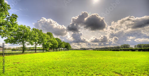 Big clouds passing by over a rural landscape in The Netherlands.