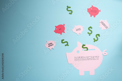 Retirement savings planning concept, IRA, 401K, pension, roth social security. Piggy bank on blue background.