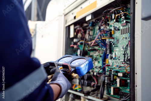 Air Conditioning Technician and A part of preparing to install new air conditioner.with Pressure Gauge and Air Purifier.