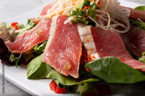 A closeup view of a seared tuna sashimi plate.