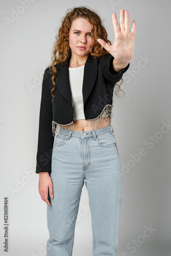 Woman With Curly Hair Holding Hand Up