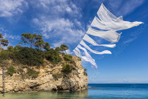White sheets waving in the wind above the beach on Cameo Island, Zakynthos, Greece
