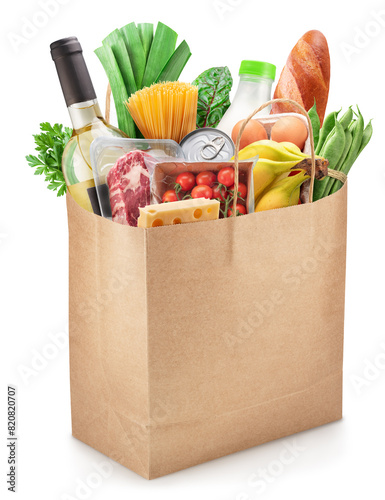 Reusable paper shopping bag full with fresh organic vegetables, fruits and other grocery products on white background. File contains clipping path.