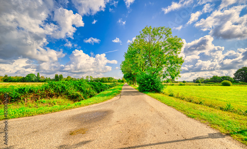 Clouds passing over a country road in a rural landschape in The Netherlands.