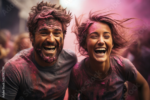 Excited couple laughing during Holi party