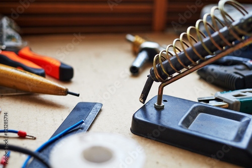 soldering iron in a spiral holder on a stand