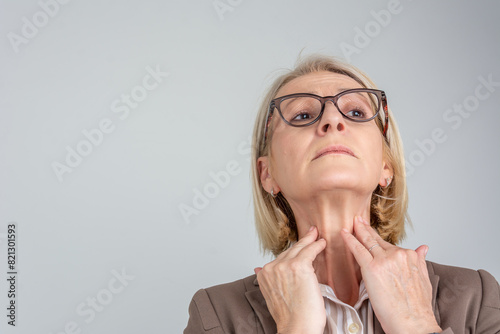 Woman thyroid gland control. Senior lady sweeping the laryngeal, laryngitis, goiter or Hypothyroidism. Disorder of the endocrine system. Hashimoto’s Thyroiditis, Lymphocytic Thyroiditis. 