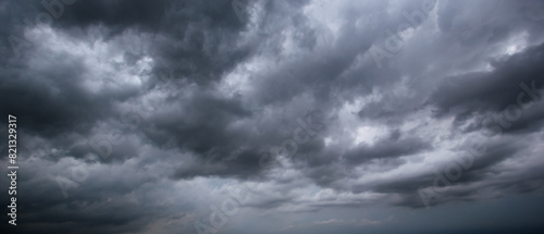 The dark sky with heavy clouds converging and a violent storm before the rain.Bad or moody weather sky and environment. carbon dioxide emissions, greenhouse effect, global warming, climate change.