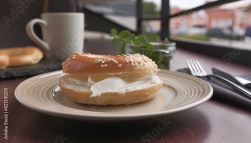 bagel with cream cheese on it, on a plate on a restaurant table