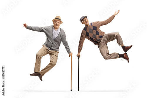 Two elderly men jumping with walking canes