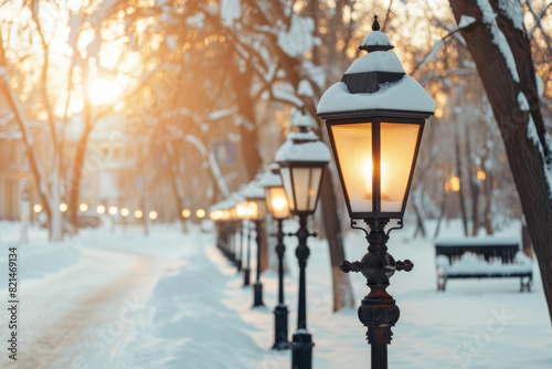 Vintage street lamps light a snowy path in a quiet park, casting a warm glow on a crisp winter evening.