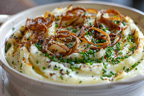 Creamy mashed potatoes swirled with truffle oil and chives, served in a sophisticated dish with a side of crispy shallots 