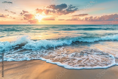 The ocean is calm and the sun is setting, creating a beautiful and serene atmosphere. The waves are gently lapping at the shore, and the sky is filled with a warm, orange glow. The scene is peaceful
