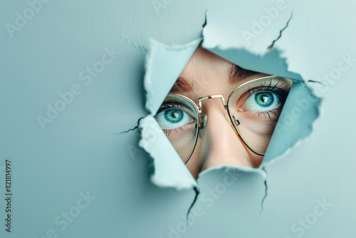 Looking through hole. Optical glasses with a eye winking