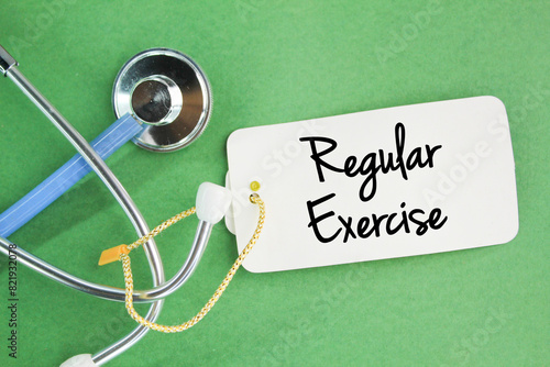 stethoscope and paper tag with the word Regular Exercise. healthy exercise concept