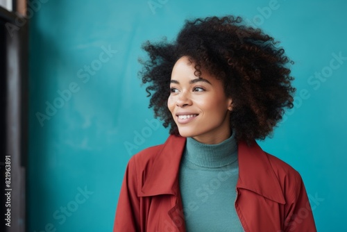 Portrait of a satisfied afro-american woman in her 30s laughing isolated on scandinavian-style interior background