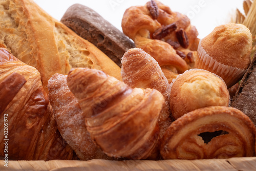 Close-up on bakery - various kinds of breadstuff. Rye bread, wholemeal, baguette, sweet bakery products and croissant