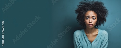 Cyan background sad black independant powerful Woman realistic person portrait of young beautiful bad mood expression girl Isolated on Background racism 