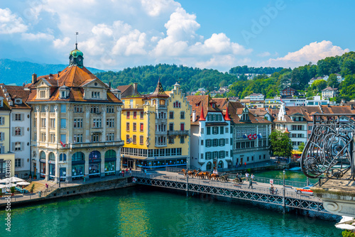 City of Lucerne with Bridge and Horse Parade in a Sunny Day in Switzerland.