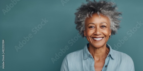 Teal Background Happy black american independant powerful Woman. Portrait of older mid aged person beautiful Smiling girl Isolated on Background ethnic diversity