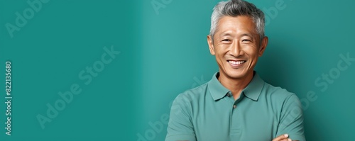 Turquoise Background Happy asian man. Portrait of older mid aged person beautiful Smiling boy good mood Isolated on Background ethnic diversity equality acceptance concept 