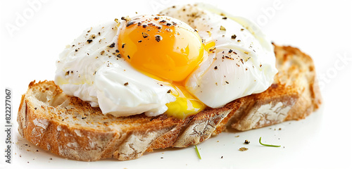 A poached egg isolated on a slice of toasted bread, with its perfectly runny yolk and delicate white.