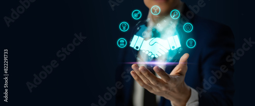 Businessmen holding virtual handshake icon for business joint venture ,strategy,data exchange customer connection,handshake,deal,empathy,join,teamwork and successful business concept.