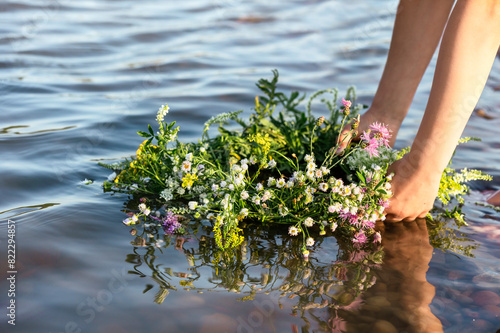 Wreath of Flowers into Water River as Symbol Ivan Kupala in Ukraine. Herbal Wreath on Water.