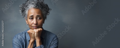 Silver background sad black American independent powerful Woman. Portrait of older mid-aged person beautiful bad mood expression girl Isolated on Background