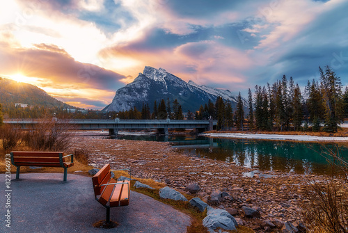 Park Benches Looking Out Over The Banff River At Sunrise