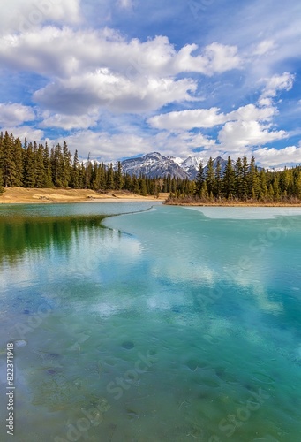 Cloudy Blue Sky Over A Semi Frozen Turquoise Lake