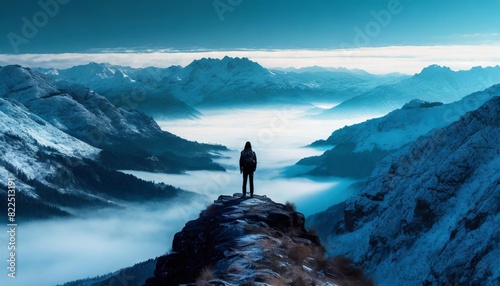 A solitary figure stands at the edge of the valley, contemplating its vastness.
