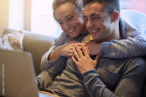 Smile, couple and relax on sofa at house together in living room with affection, bonding and love on weekend. Happy, man and woman in relationship in lounge streaming on laptop for film entertainment