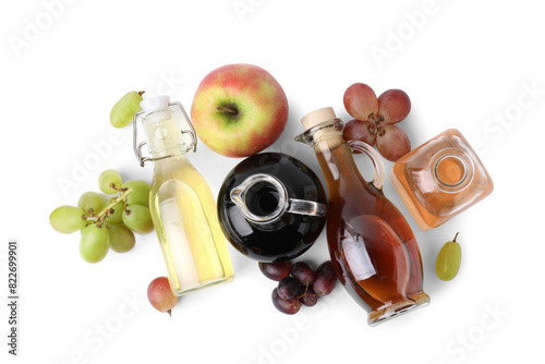 Different types of vinegar and ingredients isolated on white, top view
