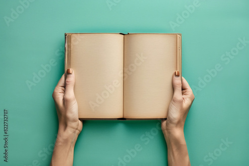 Teacher holding a blank book with a green chroma background