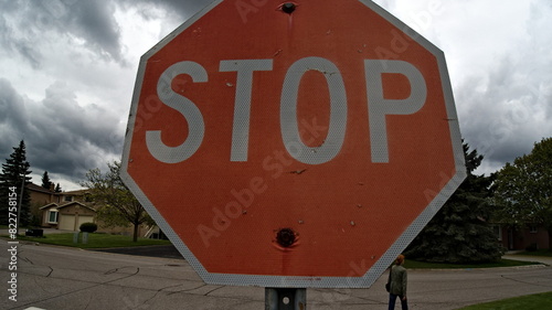 Symbolic Stop: Vibrant Red Sign Along Torontos Urban Road