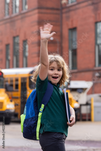 Child go to school. Schoolboy getting on school bus. American School. Happy children ready to study. Learning in USA. First day of primary school.