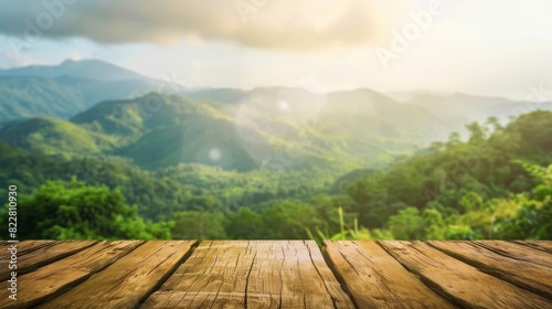 Wooden table top with blurred green mountain landscape background, nature concept for product display montage.