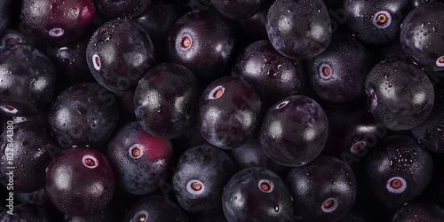 close-up image of fresh black blueberries, a closeup of the acai berries texture, showcasing their smooth and slightly glossy surface with vibrant purple and black hues