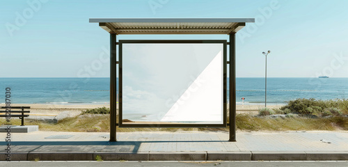 Ocean view at a seaside bus stop with a maxi vertical blank billboard.