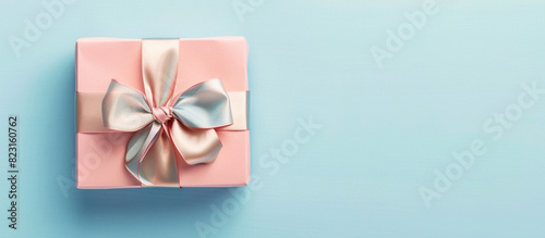 Minimalist Father's Day banner featuring a gift box with a bow on a pastel blue background, HD quality. 32k, full ultra HD, high resolution.